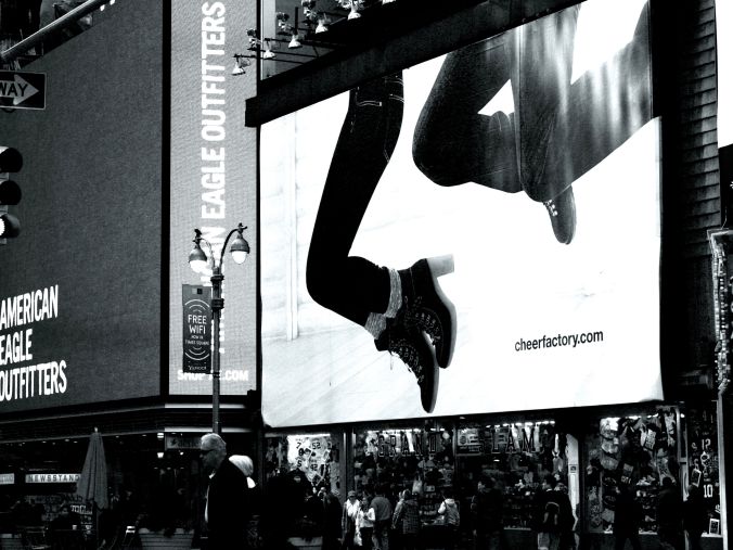 times square ad people jumping