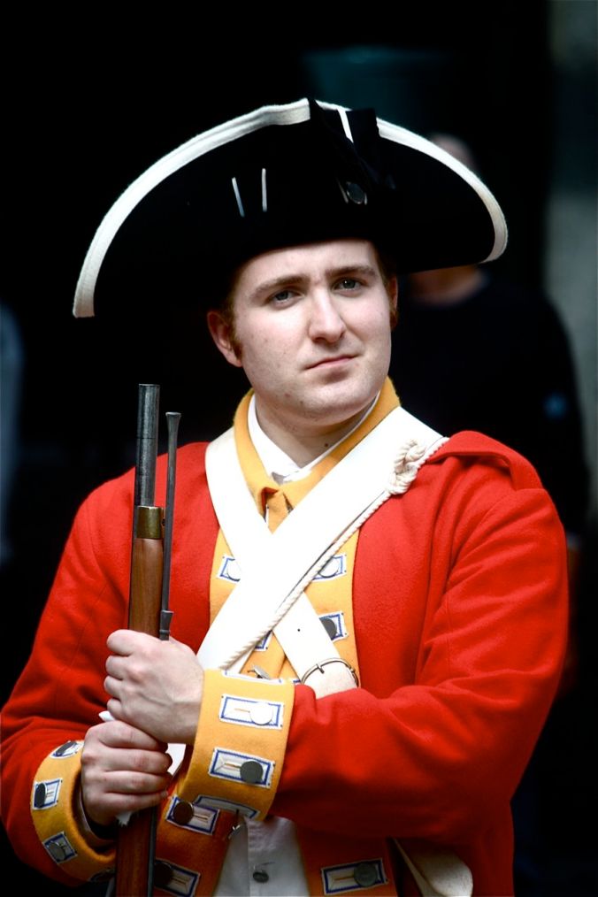boston faneuil hall man in red uniform holding gun