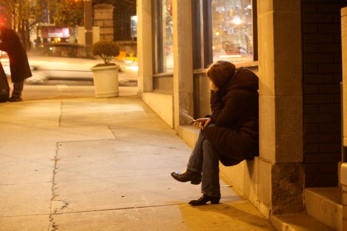 baltimore sidewalk woman smoking cigarette