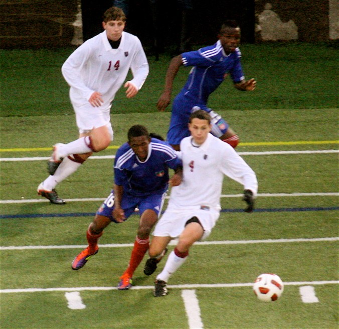 boston harvard university stadium haiti leve four players chasing ball