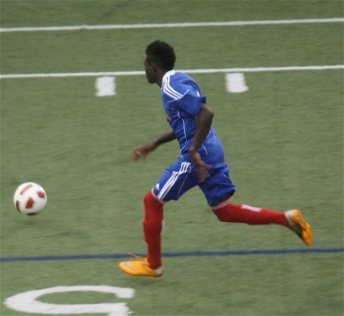 boston harvard university stadium haiti leve haitan player chasing ball