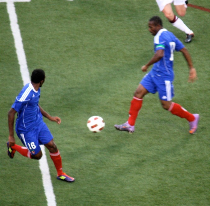 boston harvard university stadium haiti leve haitan player passing ball