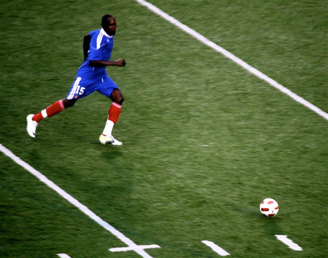 boston harvard university stadium haiti leve haitan player with ball in field