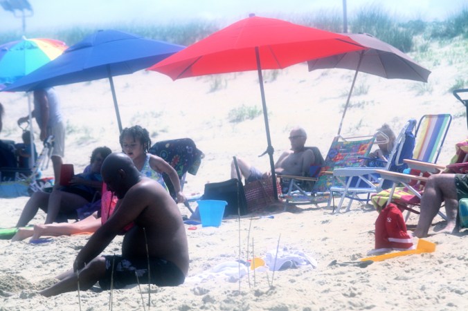 virginia beach sand bridge memorial day beach view many umbrellas