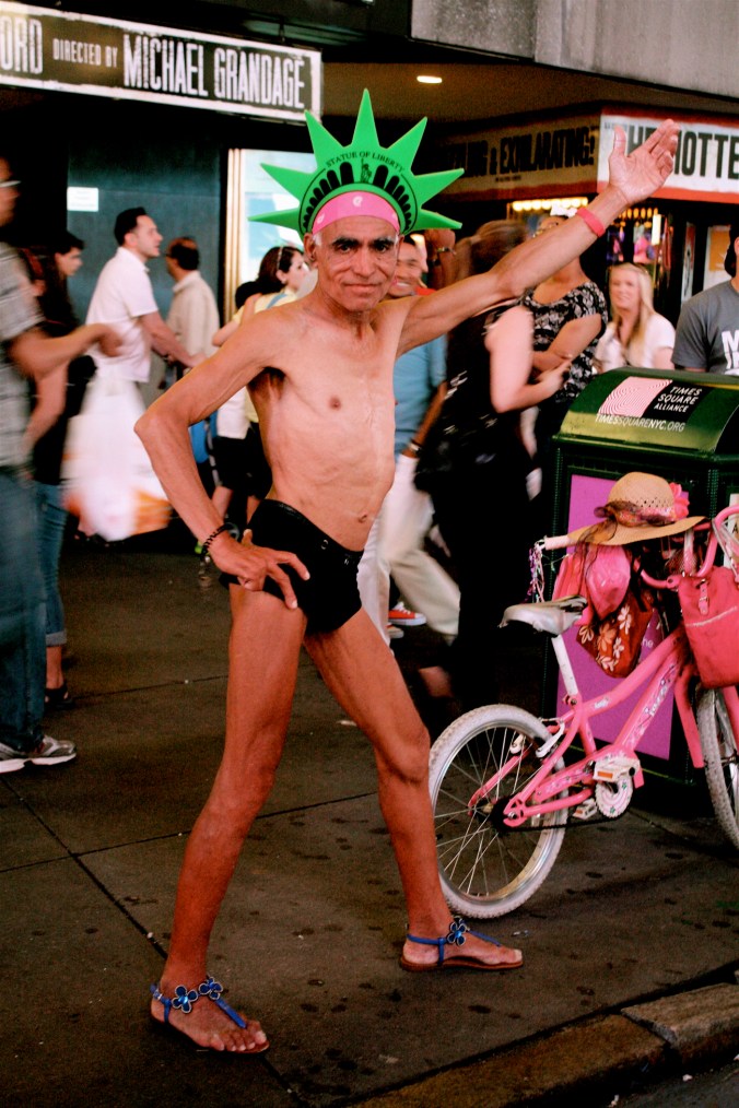 new york city times square man in underwear and statue of liberty crown