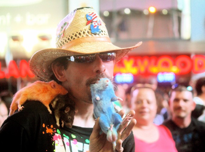 new york city times square man with rat in teeth