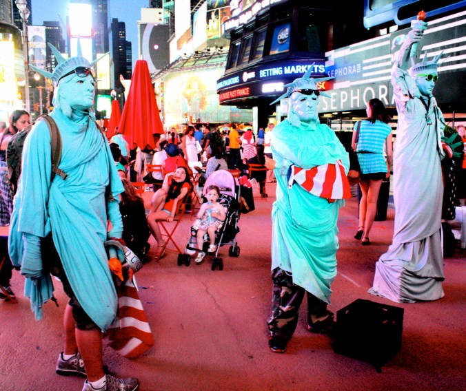 new york city times square three statues of liberty