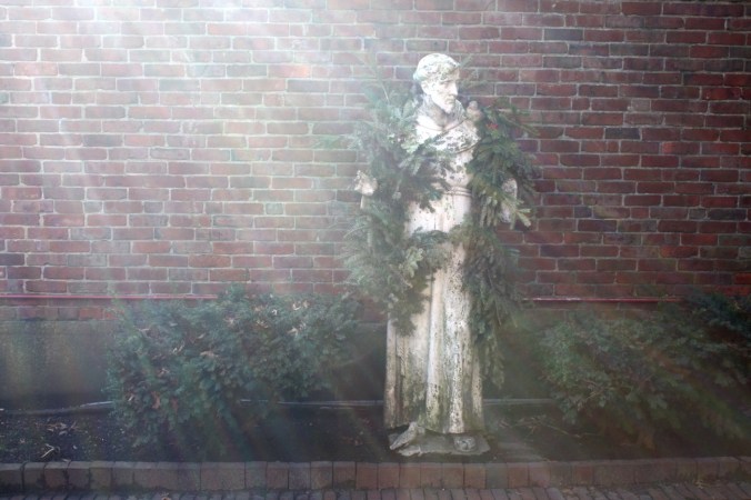 boston north end light shining on saint with wreath