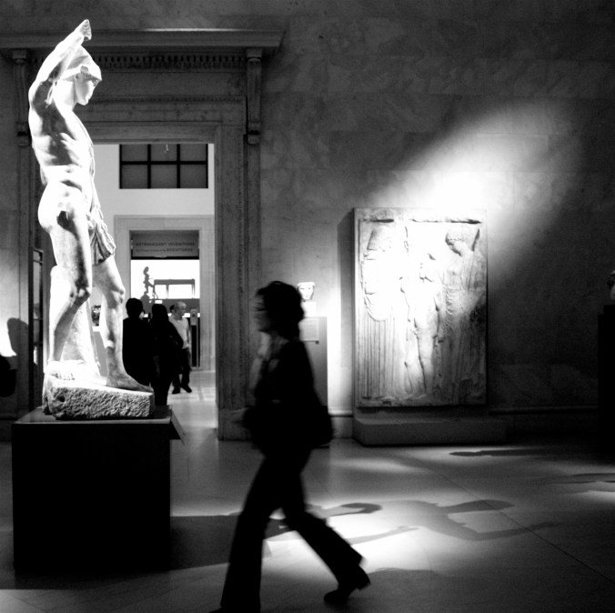 new york city metropolitan museum of art person walking by statue