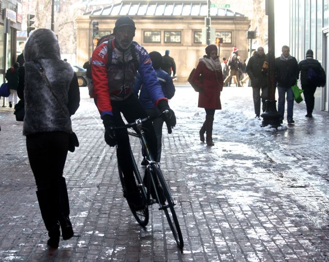 boston downtown crossing man on bicycle