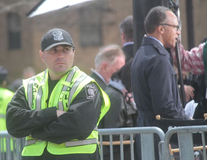 boston memorial service for victims of marathon bombing police man watching crowd