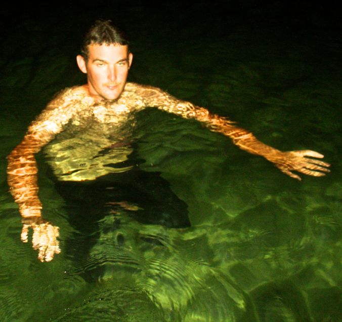 cayman islands boat guide swimming in green water 2