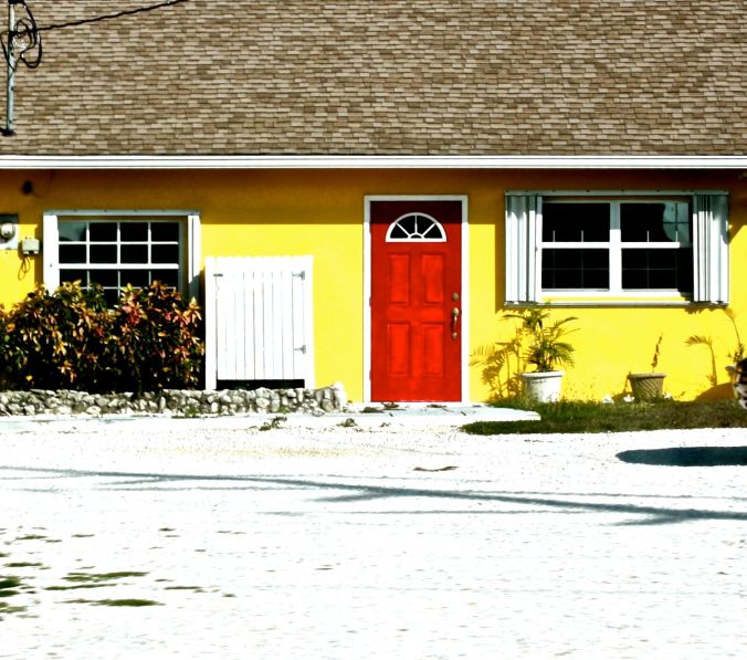 cayman islands house red door yellow walls