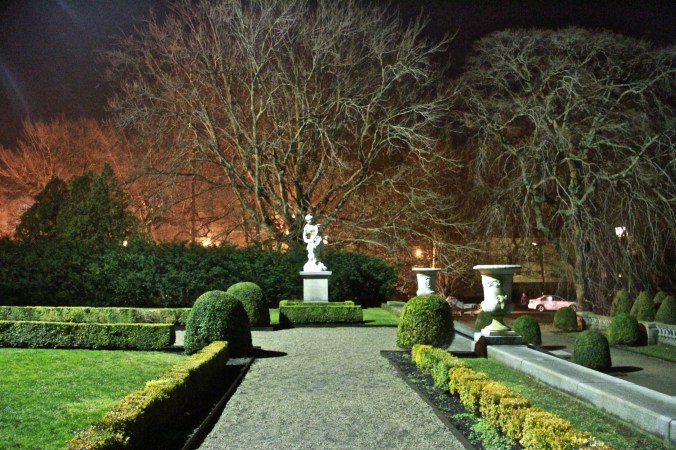 newport the elms garden night statue green orange bushes