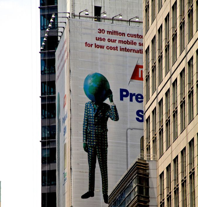 new york city times square suit with earth head advertisment