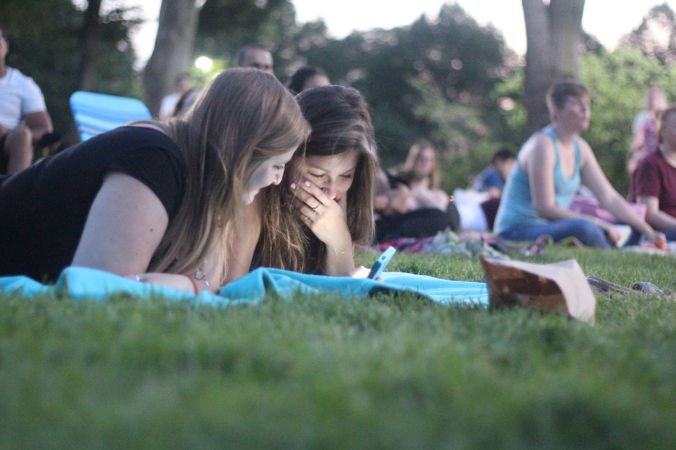 boston hatch shell night movie people girls looking at the phone