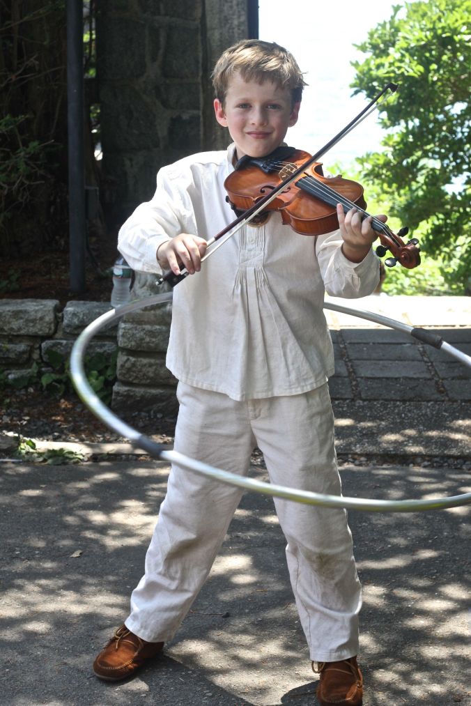 gloucester hammond castle renaissance fair boy playing the violin with hula hoop